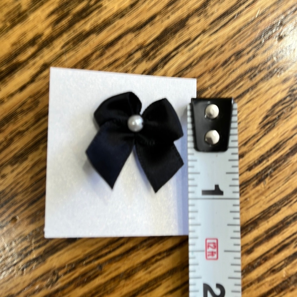 140 2 loop black bows with a pearl attached to a tie pin. Plus 60 extra bows!